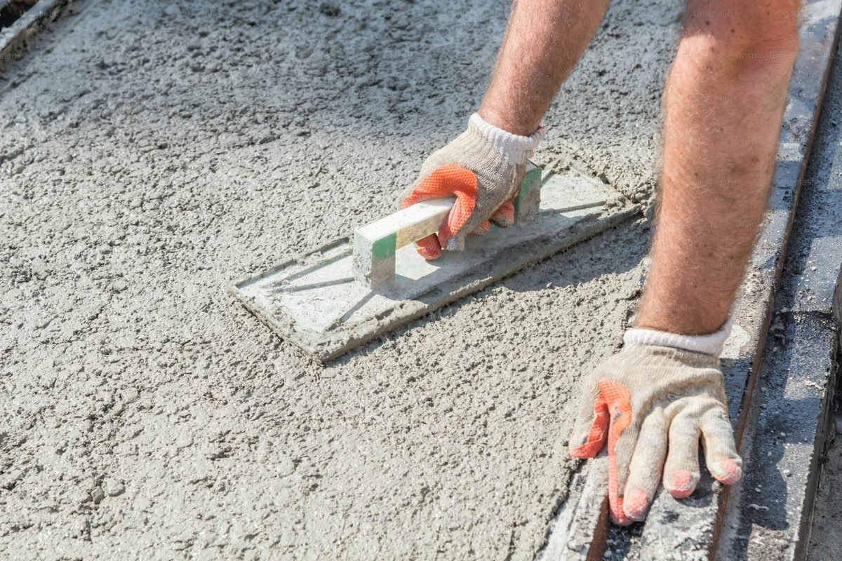Hand trowel finishing a fresh concrete surface